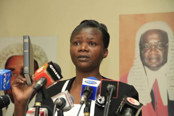 Commissioner Roselyne Aburili being sworn in